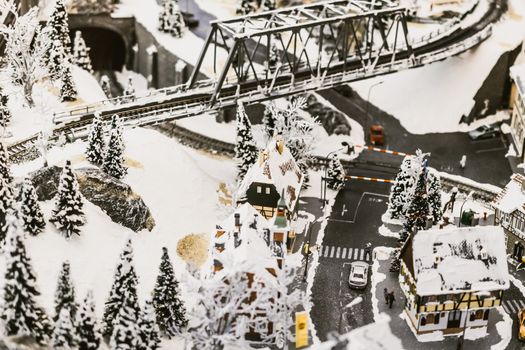 miniature city in winter - with houses, roads, cars, railway