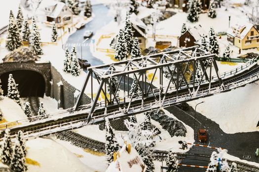 miniature city in winter - with houses, roads, cars, railway
