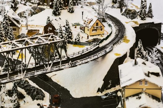 miniature city in winter - with houses, roads, cars, railway