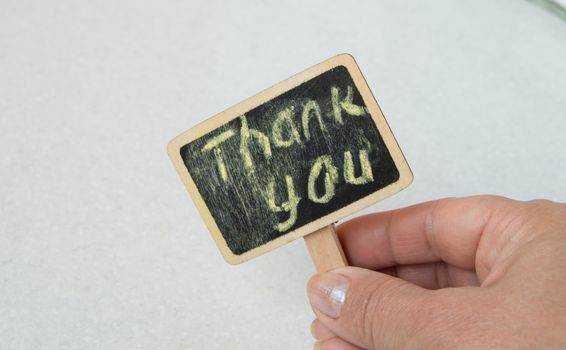 woman with a sign in her hands with the words thank you