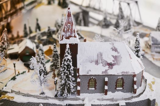 miniature city in winter - with houses, roads, cars, railway