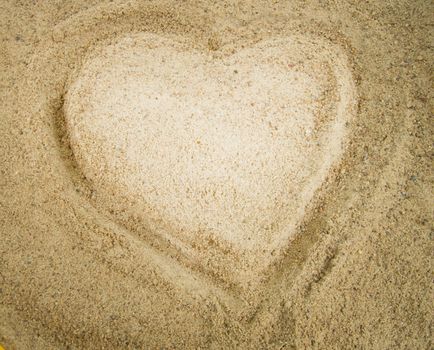 Heart drawn in the sand, a symbol of love, Valentine's.
