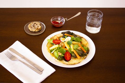 Dish of salad on a Tortilla with sauce and bread for first course