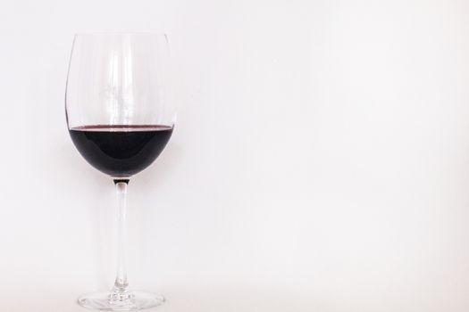 Glass of red wine with a white copy text background