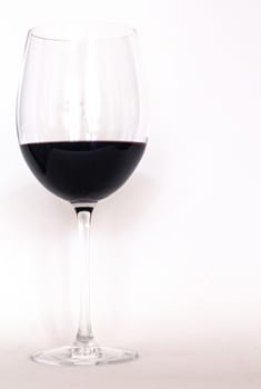 Glass of red wine with a white copy text background