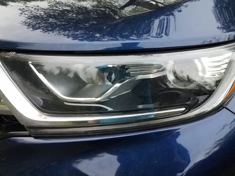 front of blue car or automobile with glass head light