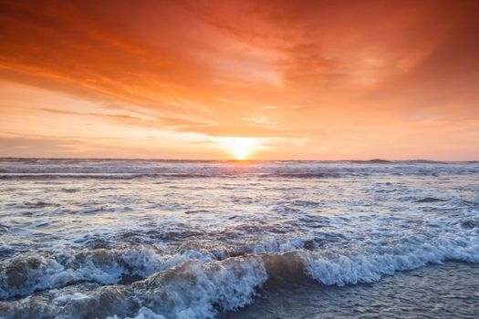 Amazing colorful sunset over sea form Bali beach