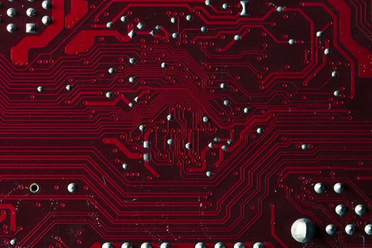Macro picture of red printed circuit board with chips
