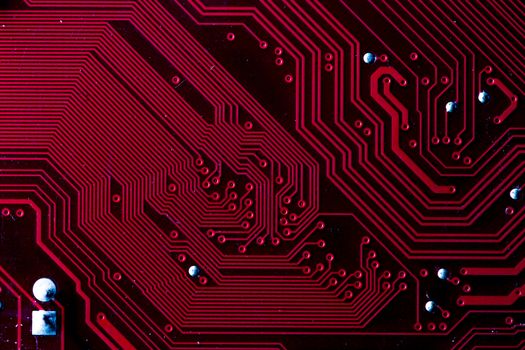 Macro picture of red printed circuit board with chips