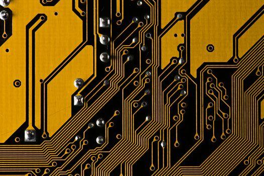 Macro picture of yellow printed circuit board with chips