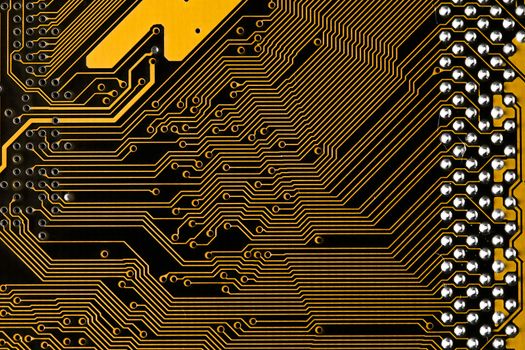 Macro picture of yellow printed circuit board with chips