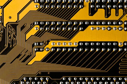 Macro picture of yellow printed circuit board with chips