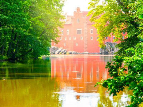 Renaissance chateau Cervena Lhota in Southern Bohemia, Czech Republic. Idyllic and picturesque fairy tale castle on the small island reflected in the romantic lake.
