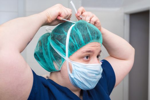 portrait of nurse with mask in surgery room