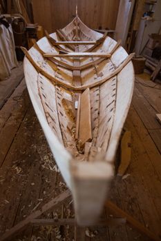 Handmade wooden boat in the barn close up view