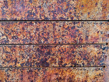 Rusty metal background with rough texture in brown tones