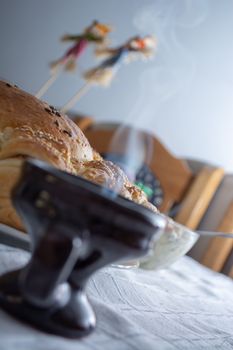 Smoke rising from Cresset on the table with food on ortodox easter