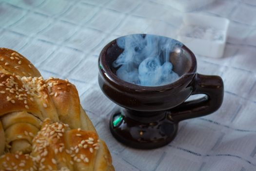 Smoke rising from Cresset on the table with food on ortodox easter