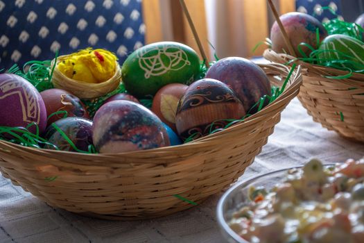 Table ful of food on easter holyday. Colored eggs and bread