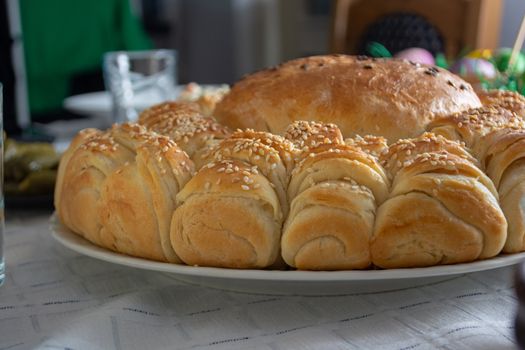 Table ful of food on easter holyday. Colored eggs and bread