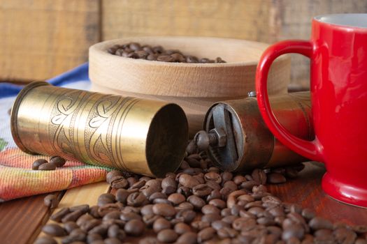 Coffee ready to be milled with old grinder. Coffee is in the table