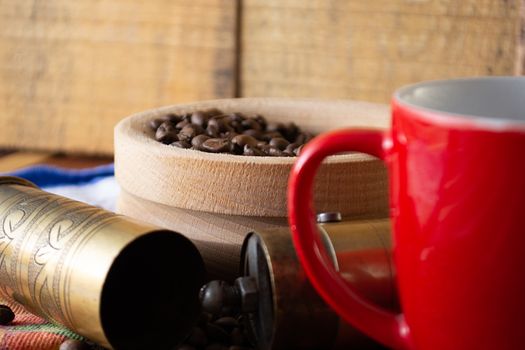 Coffee ready to be milled with old grinder. Coffee is in the table