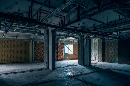 The abandoned industrial building. Fantasy interior scene. Shot in an abandoned ruin.