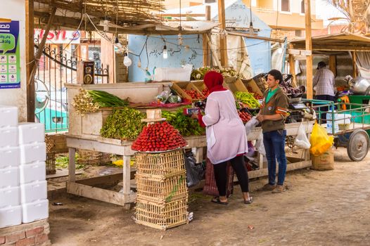 EGYPT, HURGHADA - 04 Avril 2019:Seller of fruits and vegetables in the old marina of the city of Hurghada along the Red Sea in Egypt