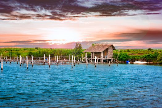 A Hut in a beautiful Scene with Water, Land and Sky