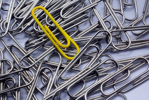 Yellow Paperclips Among a Group of Silvers