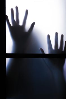 Spooky Pair of Blurred Hands through a Frosted Glass Window