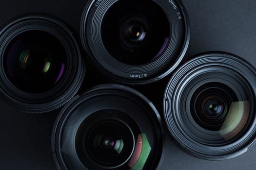 Set of various DSLR lenses with colorful reflections - shot from above