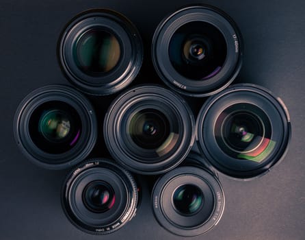 Set of various DSLR lenses with colorful reflections - shot from above