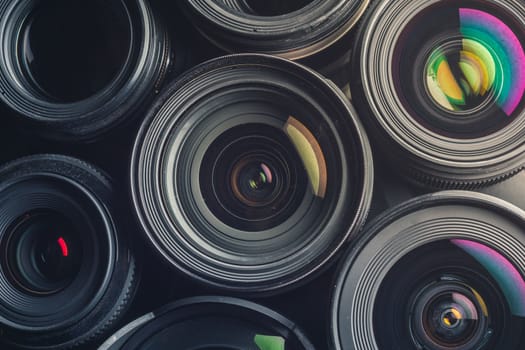 Set of various DSLR lenses with colorful reflections - shot from above