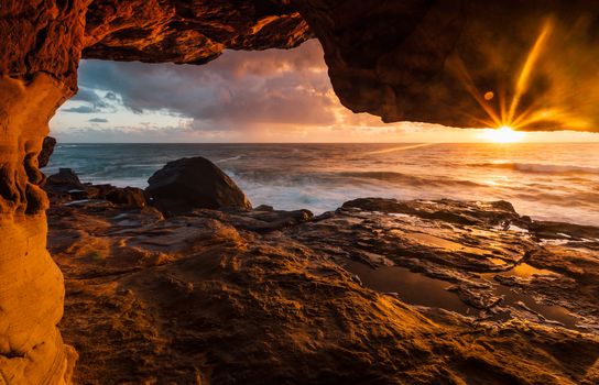 Rock tunnels carved through coastal headland to cliff ledges, so fisherman could reach these areas otherwise with no other access.  Here the rock tunnel with early morning sunlight streaming inside.