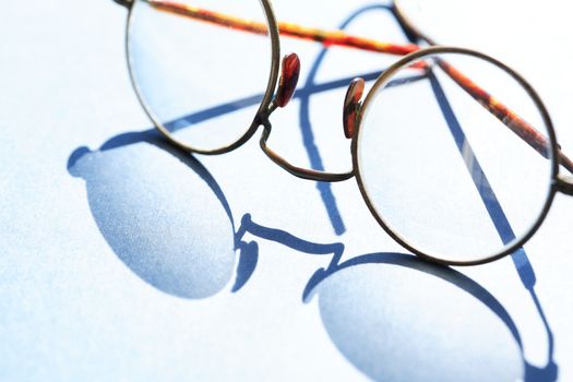 Old spectacles with shadow against sun light