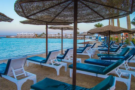 Rows of sunbeds and umbrellas on a beach in the city of Hurghada in Egypt