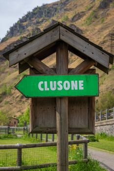 Road sign for pedestrians and bicycles indicating the direction for "Clusone" beautiful city near Bergamo.