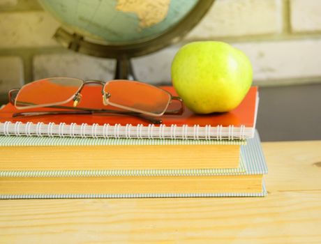 World teacher Day at school. Still life with books, globe, Apple, glasses sunlight.