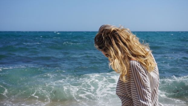 Beautiful bohemian styled and tanned girl at the sea beach in sunlight