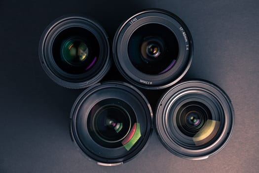 Set of various DSLR lenses with colorful reflections - shot from above