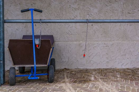pulling trolley for luggage and kids, locked and leashed on a metal bar, outdoor transportation