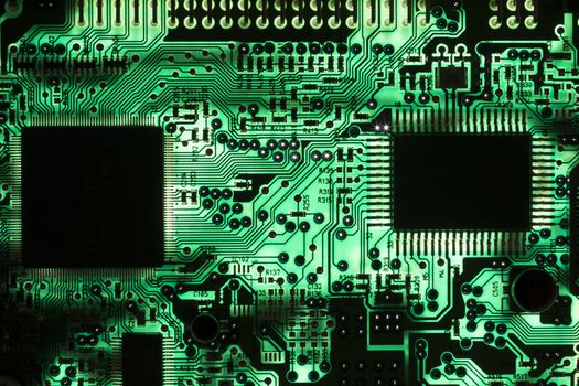 Macro picture of backlit printed circuit board with chips