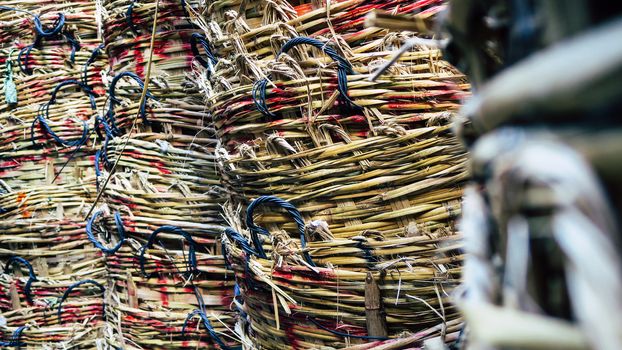 Stack of big wicker baskets in market