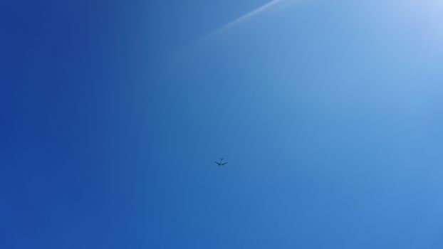 Airplane frying in the blue sky - sunny day