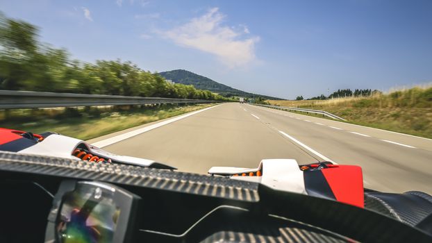 Super fast ride in convertible sportscar on highway.