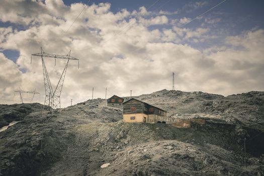 Cabin in the mountains with high voltage wires.