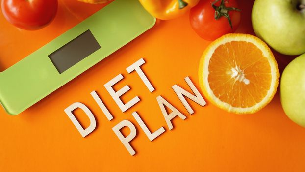 Concept diet. Healthy food, kitchen weight scale. Vegetables and fruits lettering Diet plan
