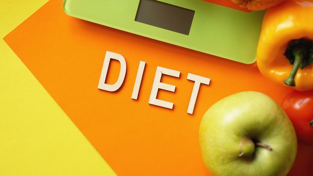 Concept diet. Healthy food, kitchen weight scale. Vegetables and fruits. Top view close-up on orange background