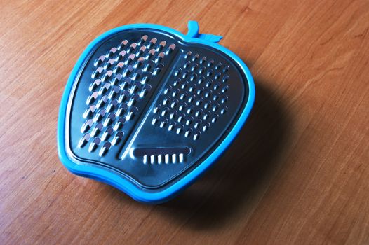 Metal grater for vegetables on the table